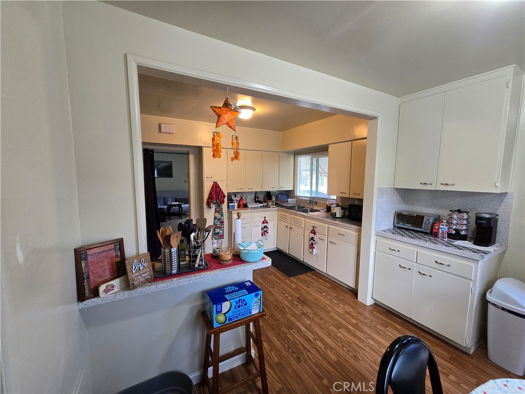 7457 Mt Vernon Street Riverside, CA 92504 - Photo 7 of 23 a kitchen with white cabinets and appliances