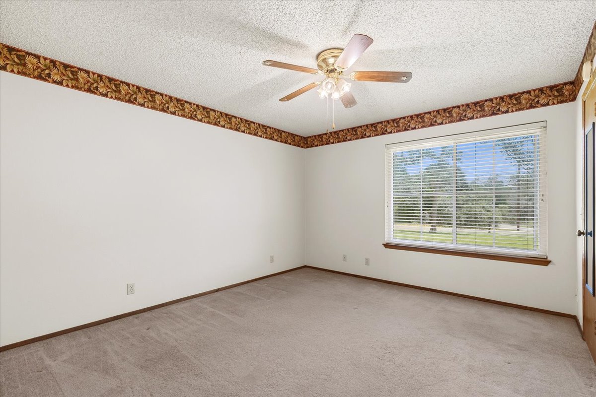 250 Hickory Drive Elgin, TX 78621 - Photo 20 of 37 a view of a big room with windows and chandelier fan