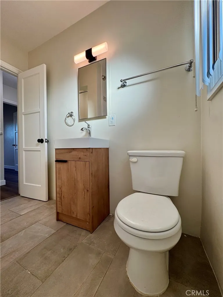 3402 Gaviota Avenue, Unit B Long Beach, CA 90807 - Photo 14 of 22 a bathroom with a toilet a sink and mirror