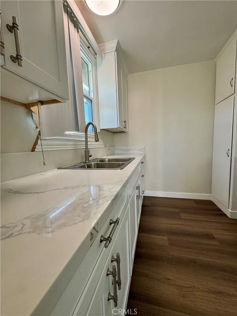 3402 Gaviota Avenue, Unit B Long Beach, CA 90807 - Photo 5 of 22 a kitchen with a sink and a mirror