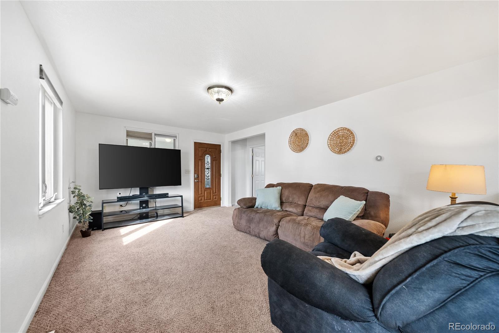 550 Custer Avenue Akron, CO 80720 - Photo 11 of 35 a living room with furniture and a flat screen tv