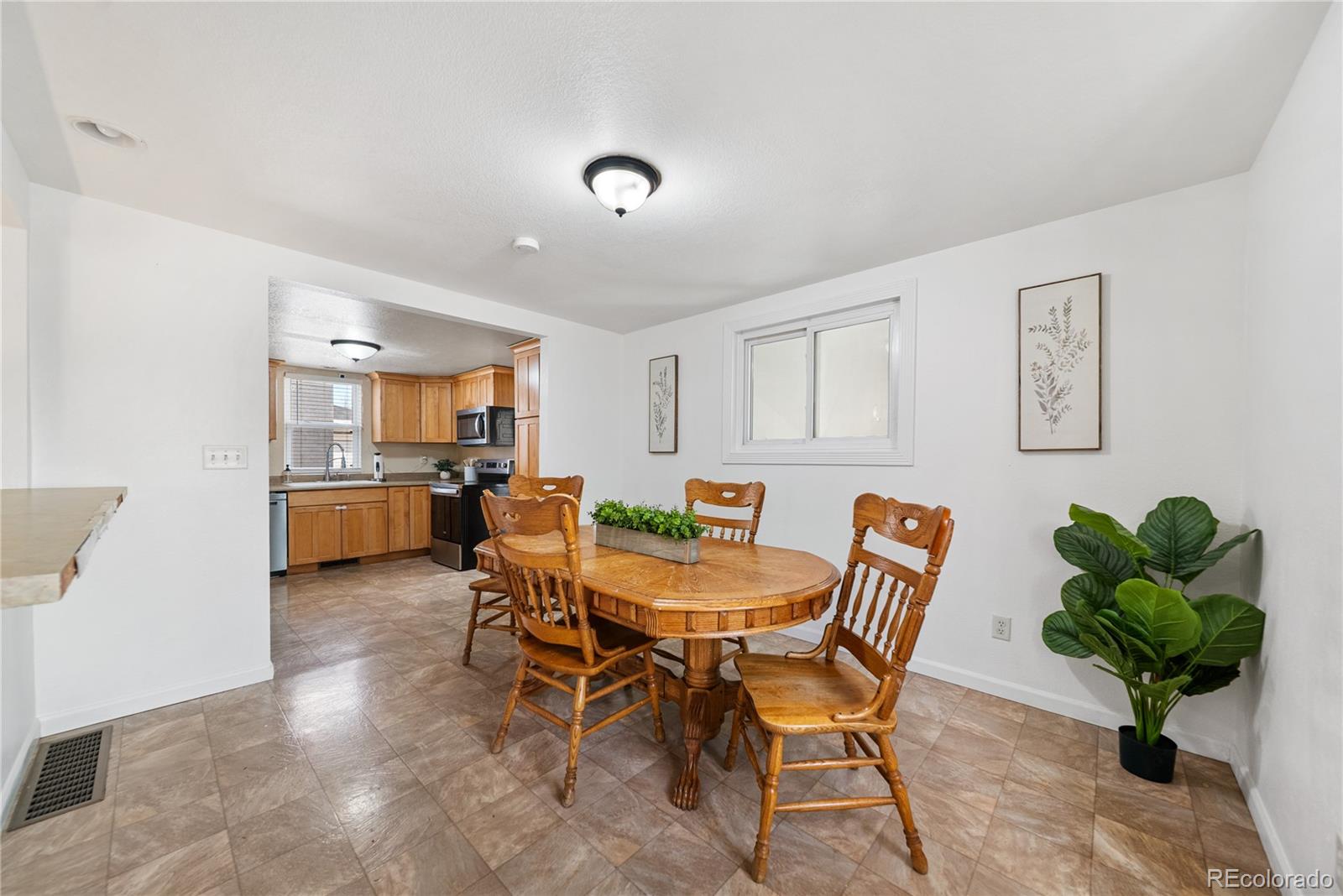 550 Custer Avenue Akron, CO 80720 - Photo 12 of 35 a view of a dining room with furniture and a potted plant