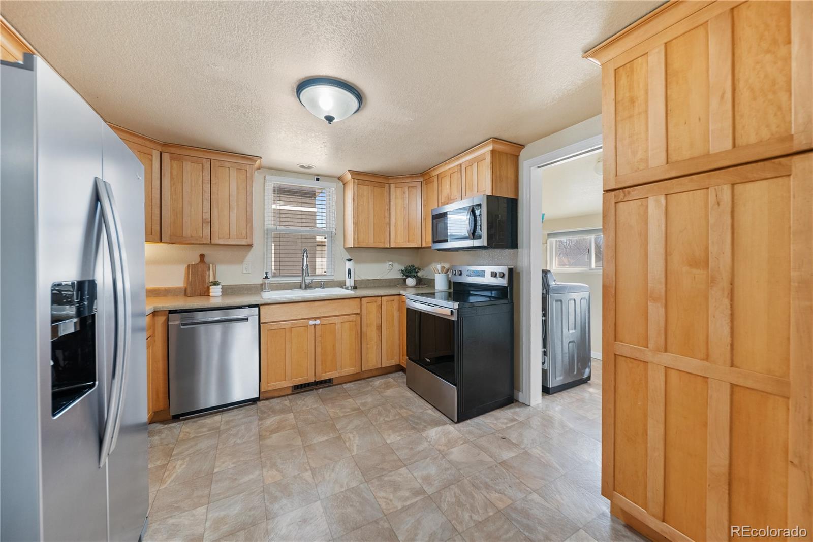550 Custer Avenue Akron, CO 80720 - Photo 15 of 35 a kitchen with stainless steel appliances granite countertop a refrigerator sink and microwave
