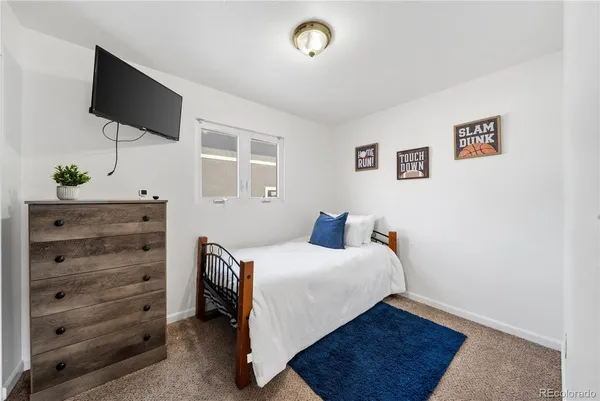 an entryway with a cabinet and a rug