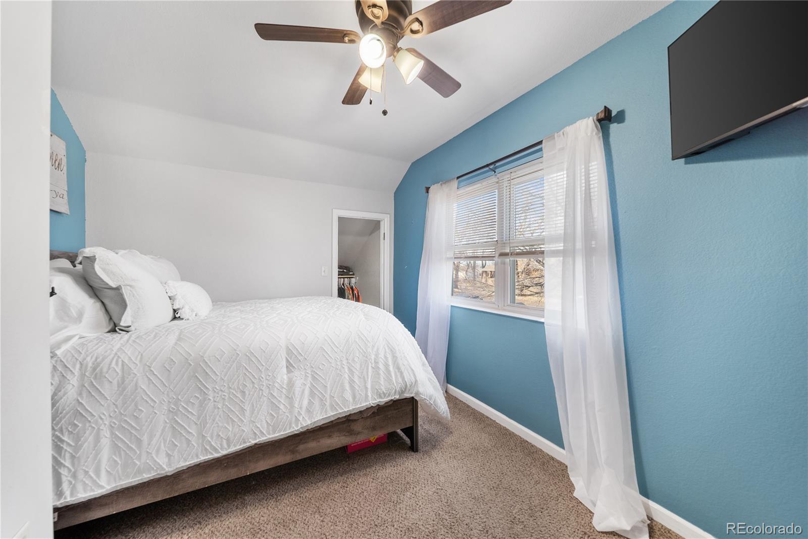550 Custer Avenue Akron, CO 80720 - Photo 26 of 35 a bedroom with a bed and a window