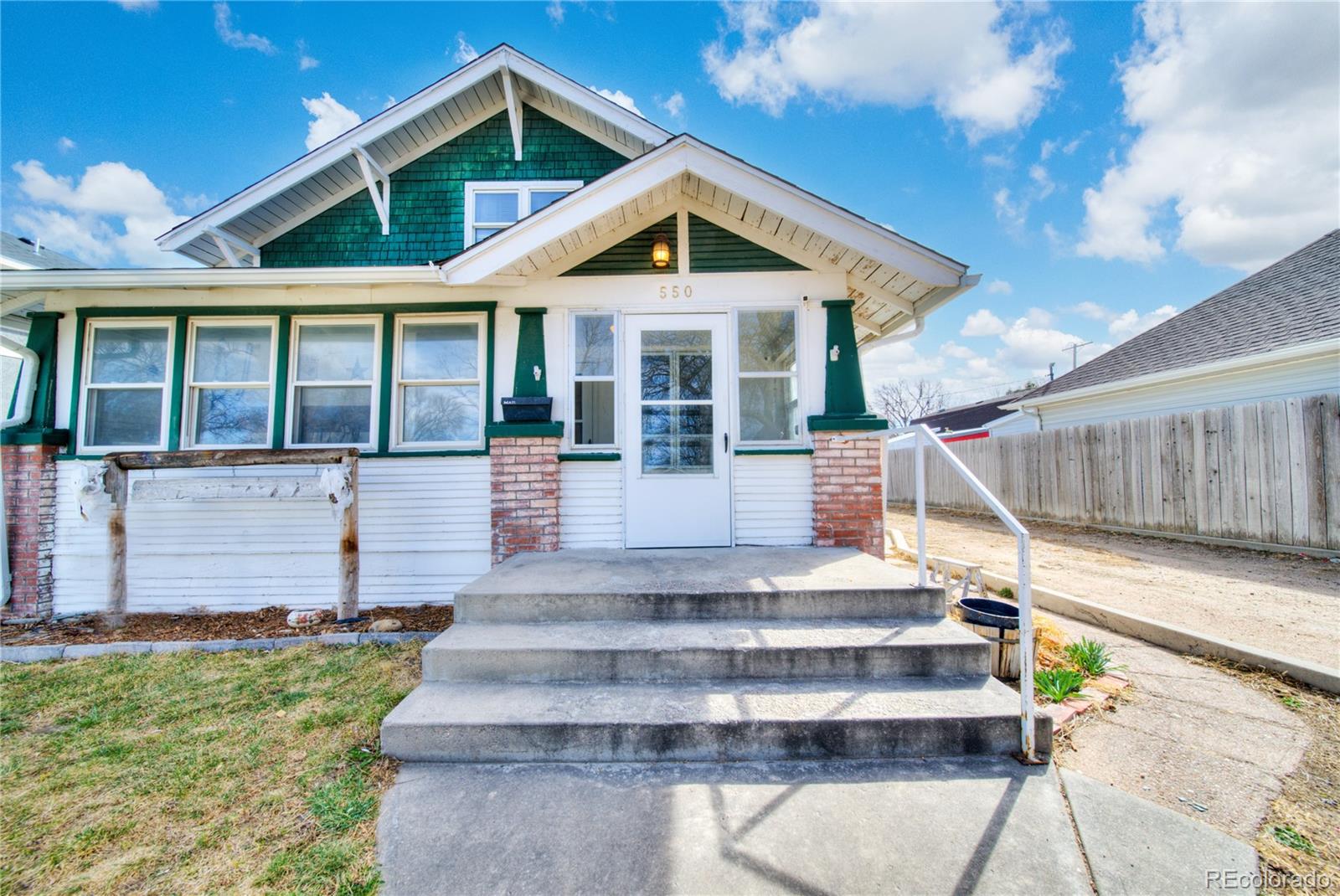 550 Custer Avenue Akron, CO 80720 - Photo 3 of 35 a front view of a house with garden