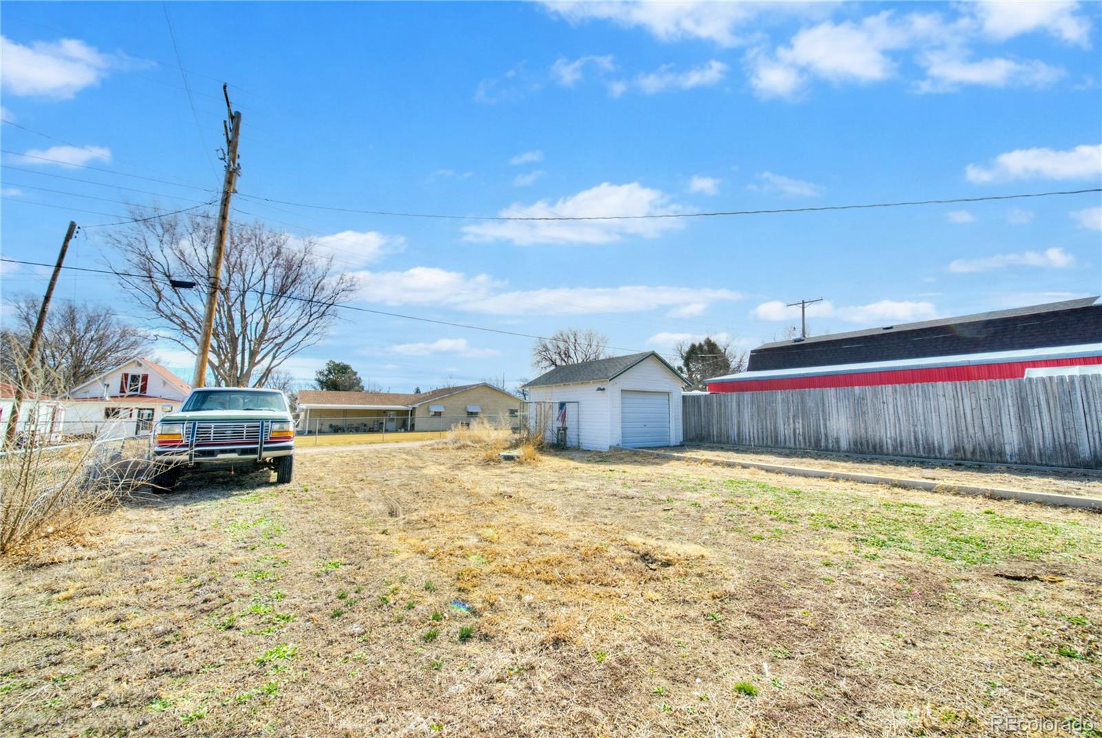 550 Custer Avenue Akron, CO 80720 - Photo 31 of 35 a view of a house with a yard and car parked