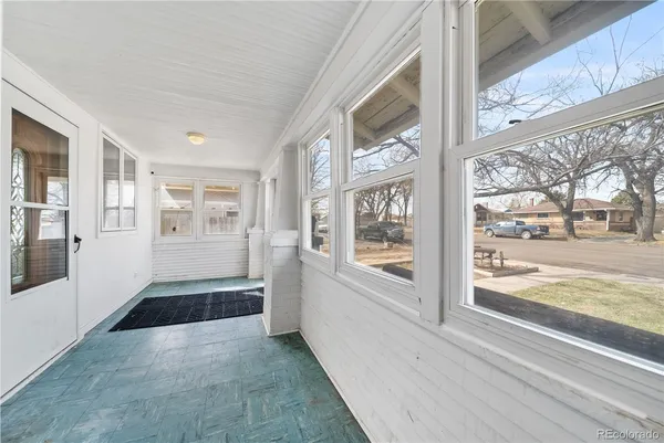 a view of a room with window and front door