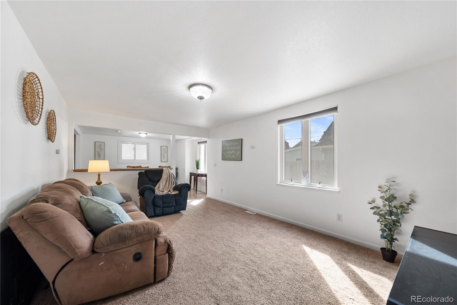 550 Custer Avenue Akron, CO 80720 - Photo 10 of 35 a living room with furniture and a window