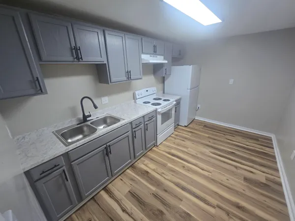 a kitchen with a sink stove and cabinets