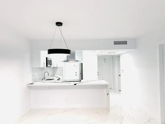 a room with a sink a lamp and a lamp