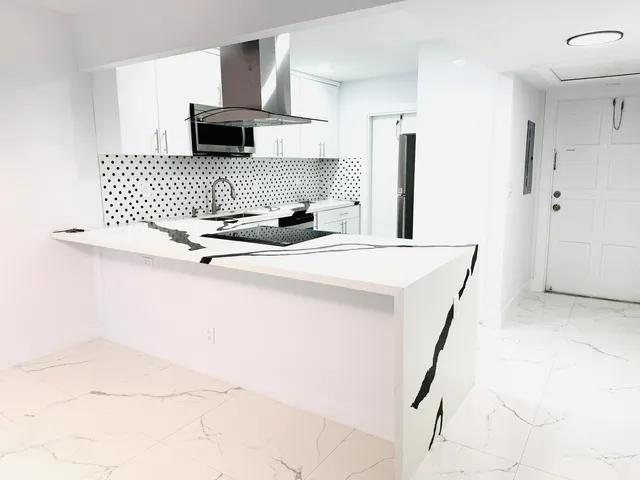 a kitchen with a sink a stove and a refrigerator