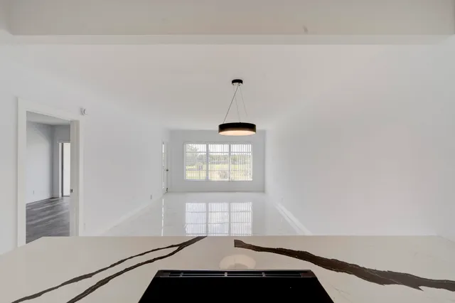 a view of a room with window and ceiling fan