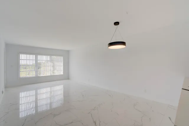 a room with a window and a chandelier