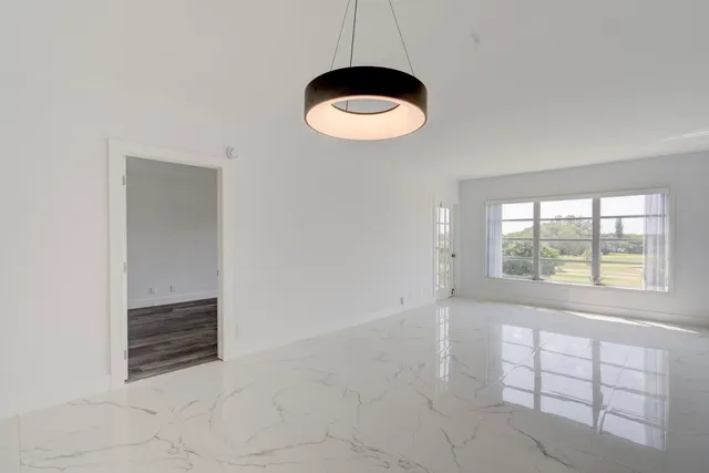 an empty room with a empty space and windows