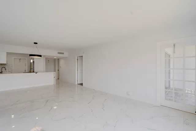 a view of kitchen and empty room