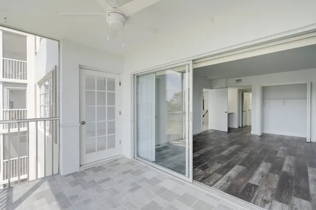 view of empty room with wooden floor and fan