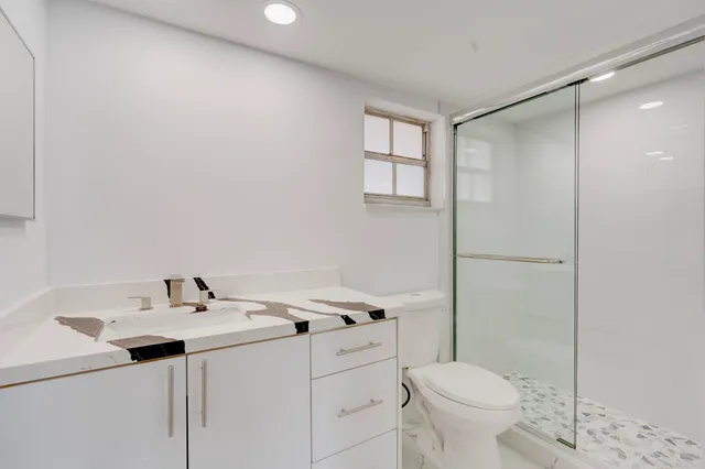 a bathroom with a sink toilet and vanity