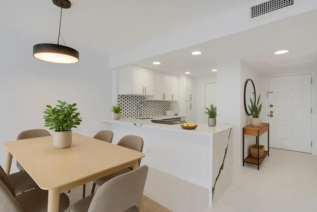 a view of a dining room with furniture and a chandelier