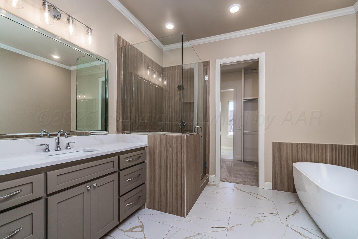 6304 Lauren Ashleigh Drive Amarillo, TX 79119 - Photo 19 of 38 a spacious bathroom with a bathtub shower sink and mirror