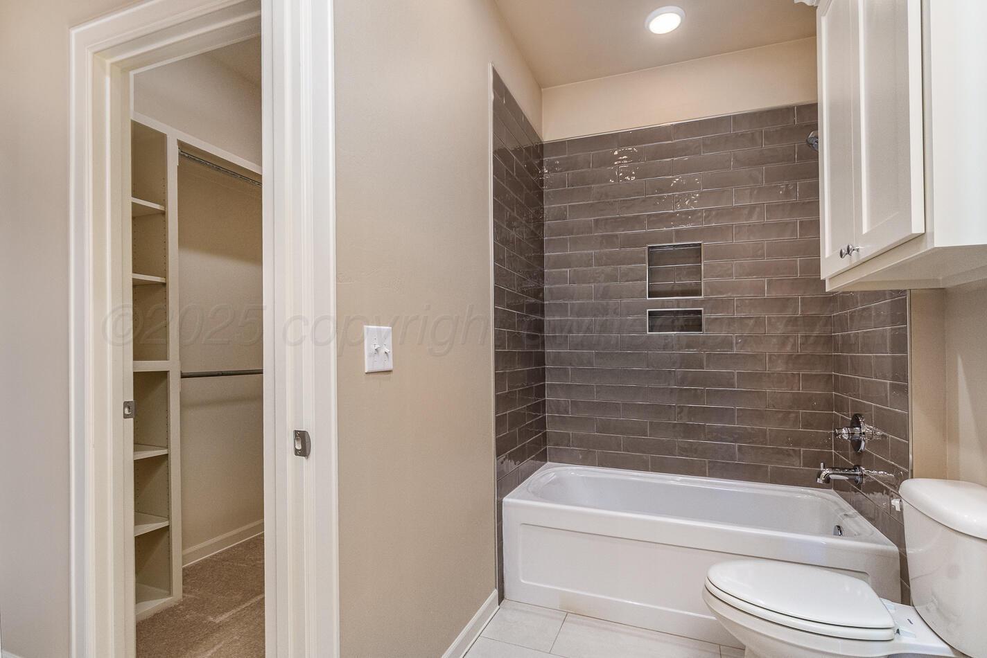 6304 Lauren Ashleigh Drive Amarillo, TX 79119 - Photo 29 of 38 a bathroom with a toilet and a bathtub