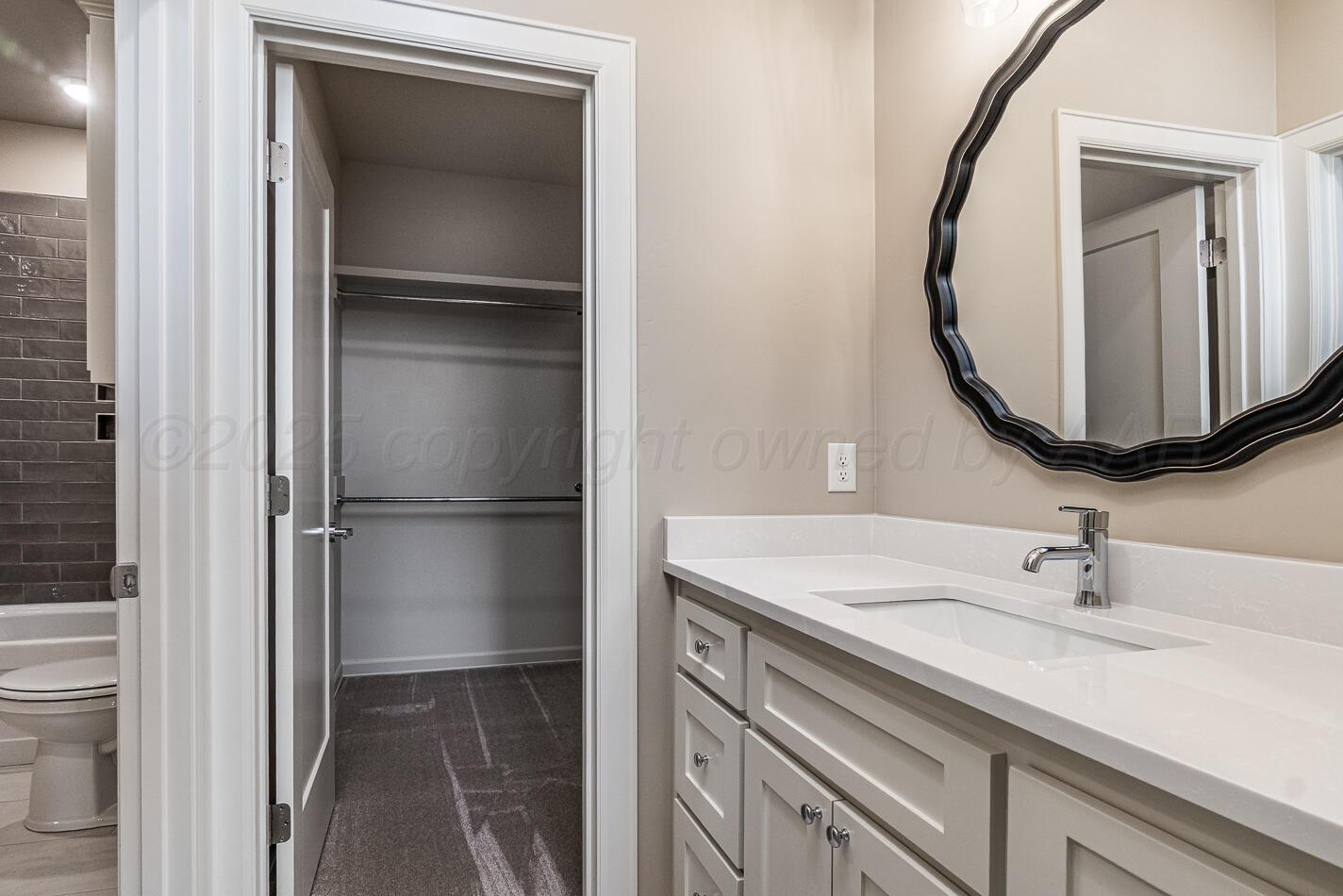 6304 Lauren Ashleigh Drive Amarillo, TX 79119 - Photo 30 of 38 a bathroom with a sink and a mirror
