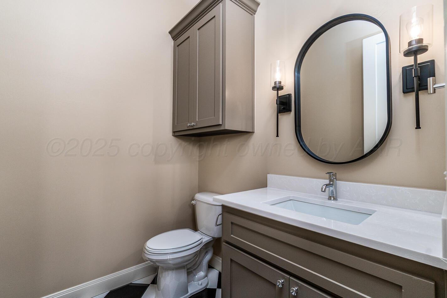 6304 Lauren Ashleigh Drive Amarillo, TX 79119 - Photo 34 of 38 a bathroom with a toilet a sink and mirror