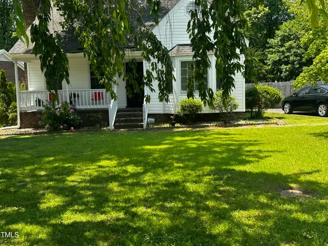 a view of a fountain in front of a house with a big yard