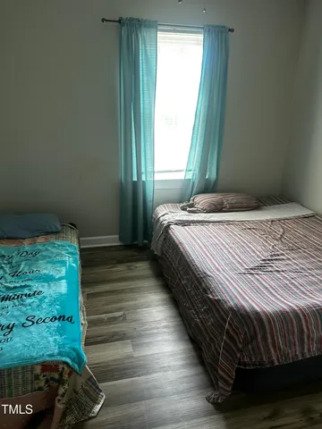 a room with a window and a wooden floor