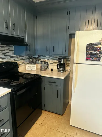 a kitchen with a refrigerator and a stove