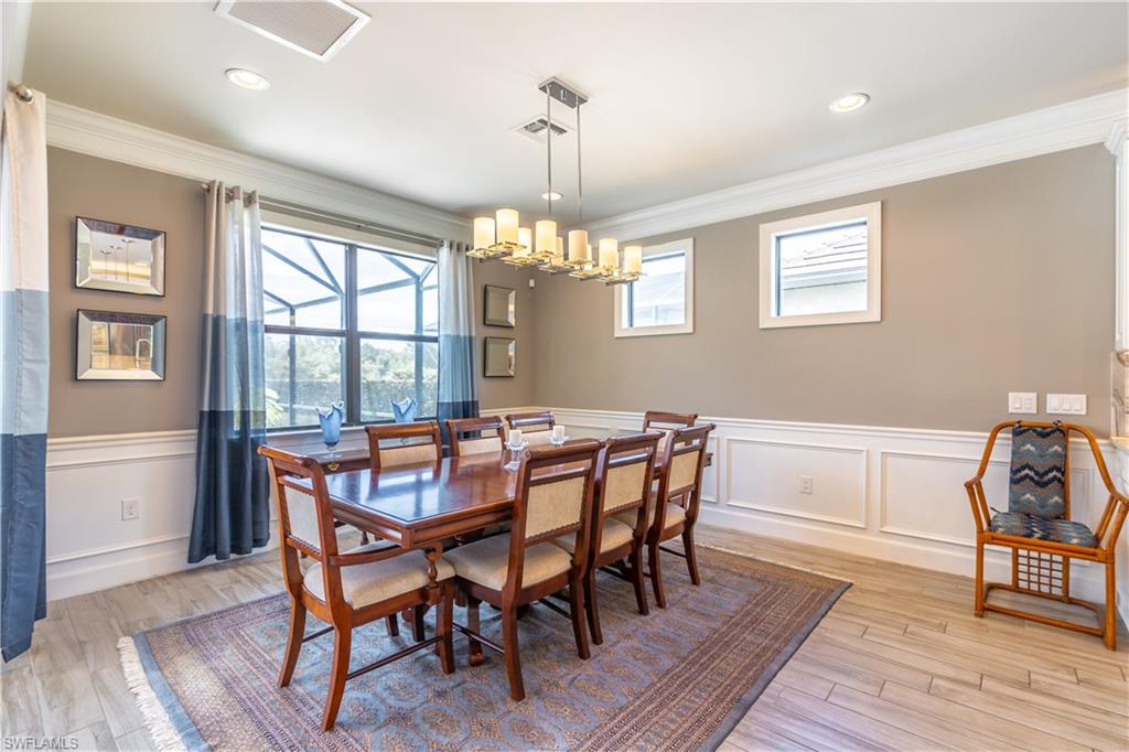 7247 Clamshell Lane Naples, FL 34114 - Photo 14 of 33 a view of a dining room with furniture window and wooden floor