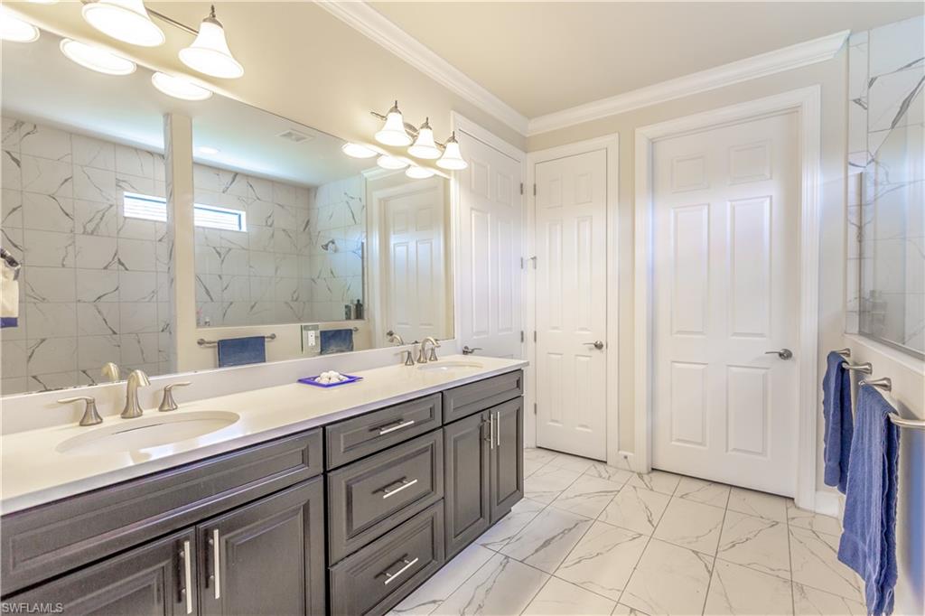 7247 Clamshell Lane Naples, FL 34114 - Photo 17 of 33 a spacious bathroom with a double vanity sink mirror and double