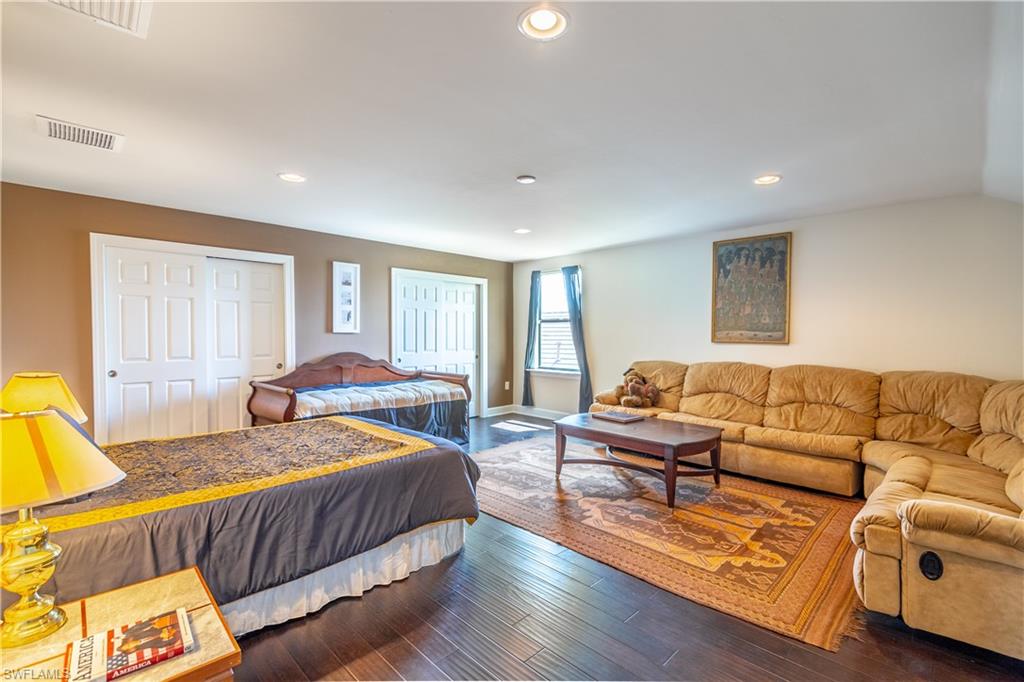 7247 Clamshell Lane Naples, FL 34114 - Photo 22 of 33 a bedroom with a bed couch and window