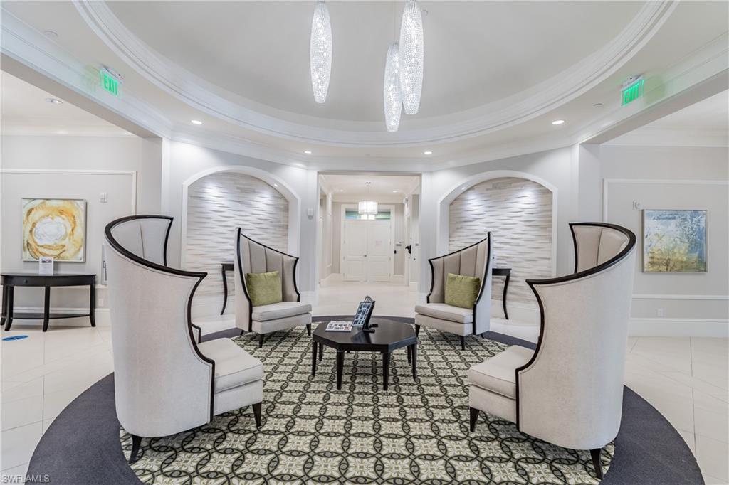 7247 Clamshell Lane Naples, FL 34114 - Photo 29 of 33 a living room with furniture a chandelier and a painting