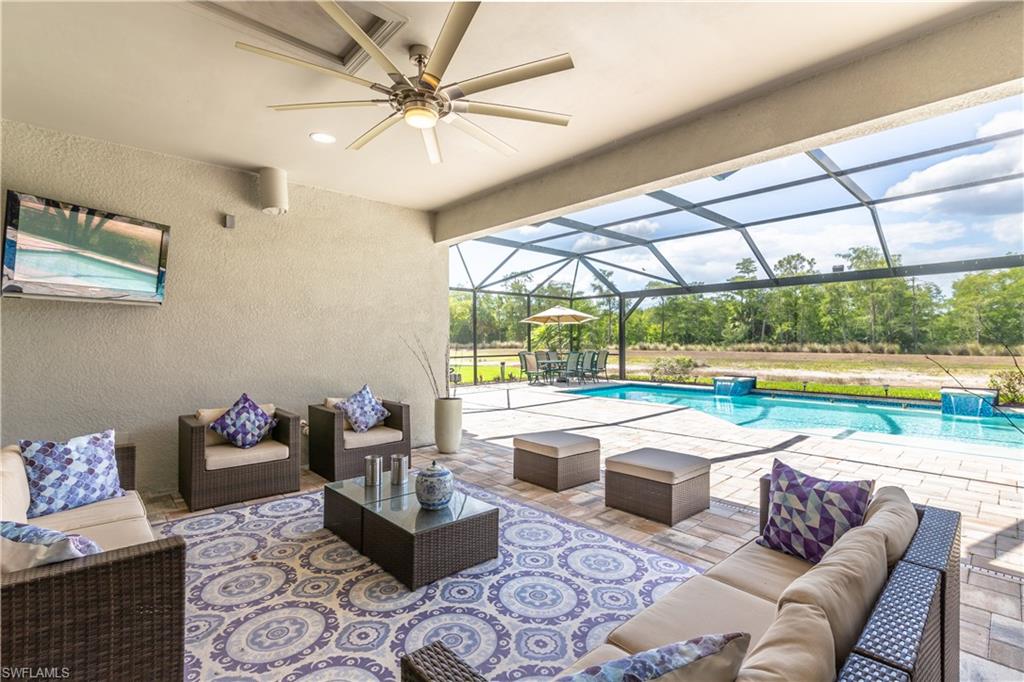7247 Clamshell Lane Naples, FL 34114 - Photo 7 of 33 a living room with couch and a floor to ceiling window