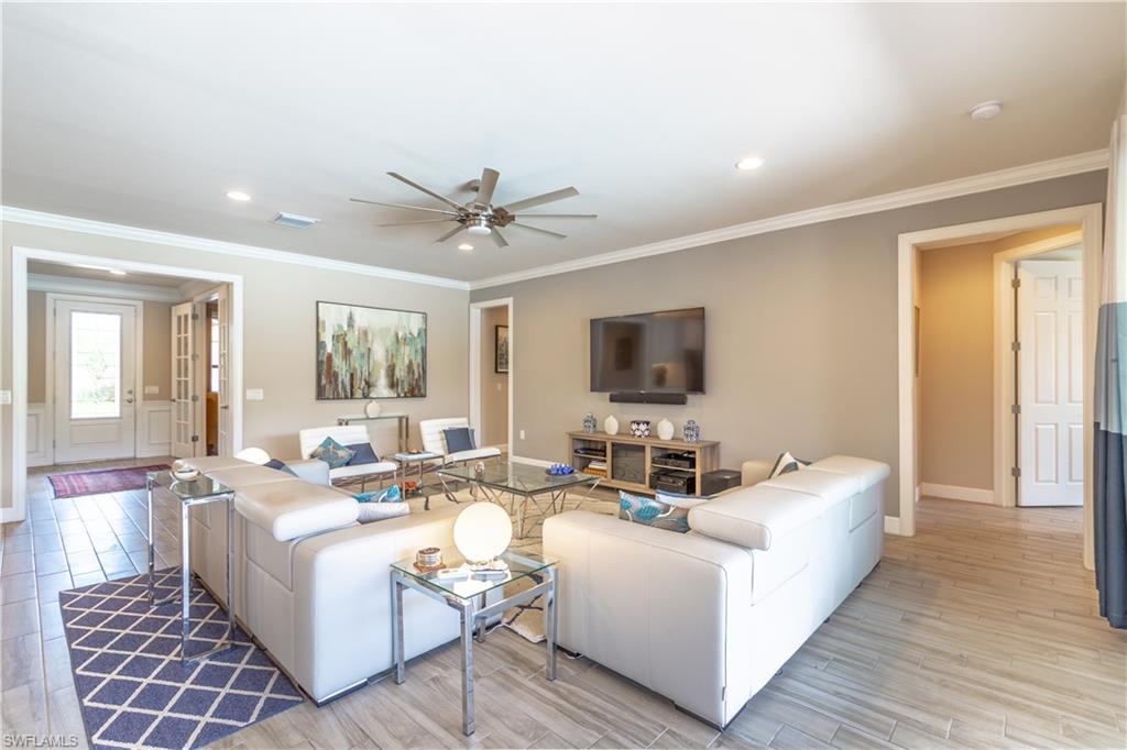 7247 Clamshell Lane Naples, FL 34114 - Photo 10 of 33 a living room with furniture and a flat screen tv