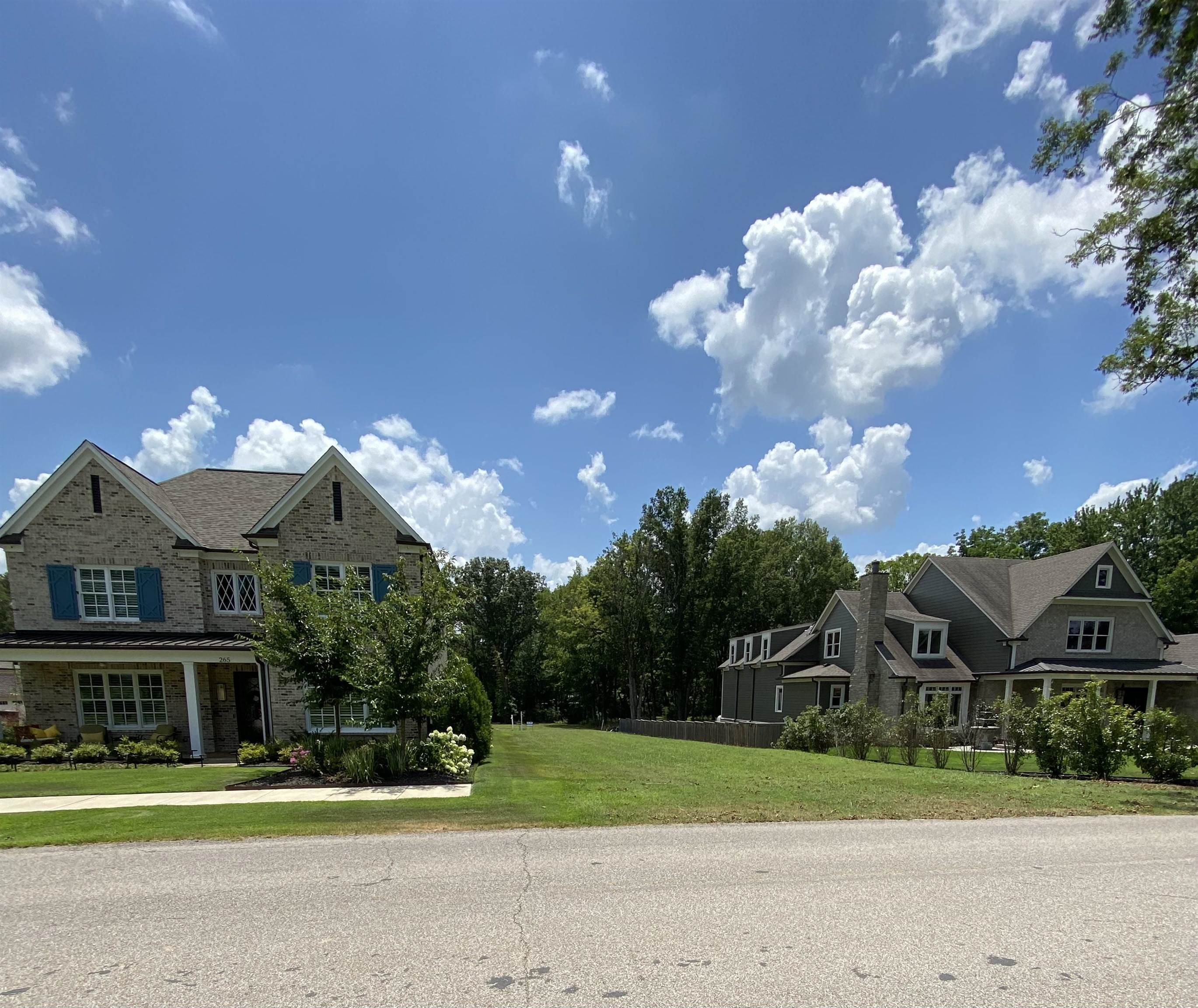 259 Washington Street Collierville, TN 38017 - Photo 2 of 5 a front view of a house with a garden and trees