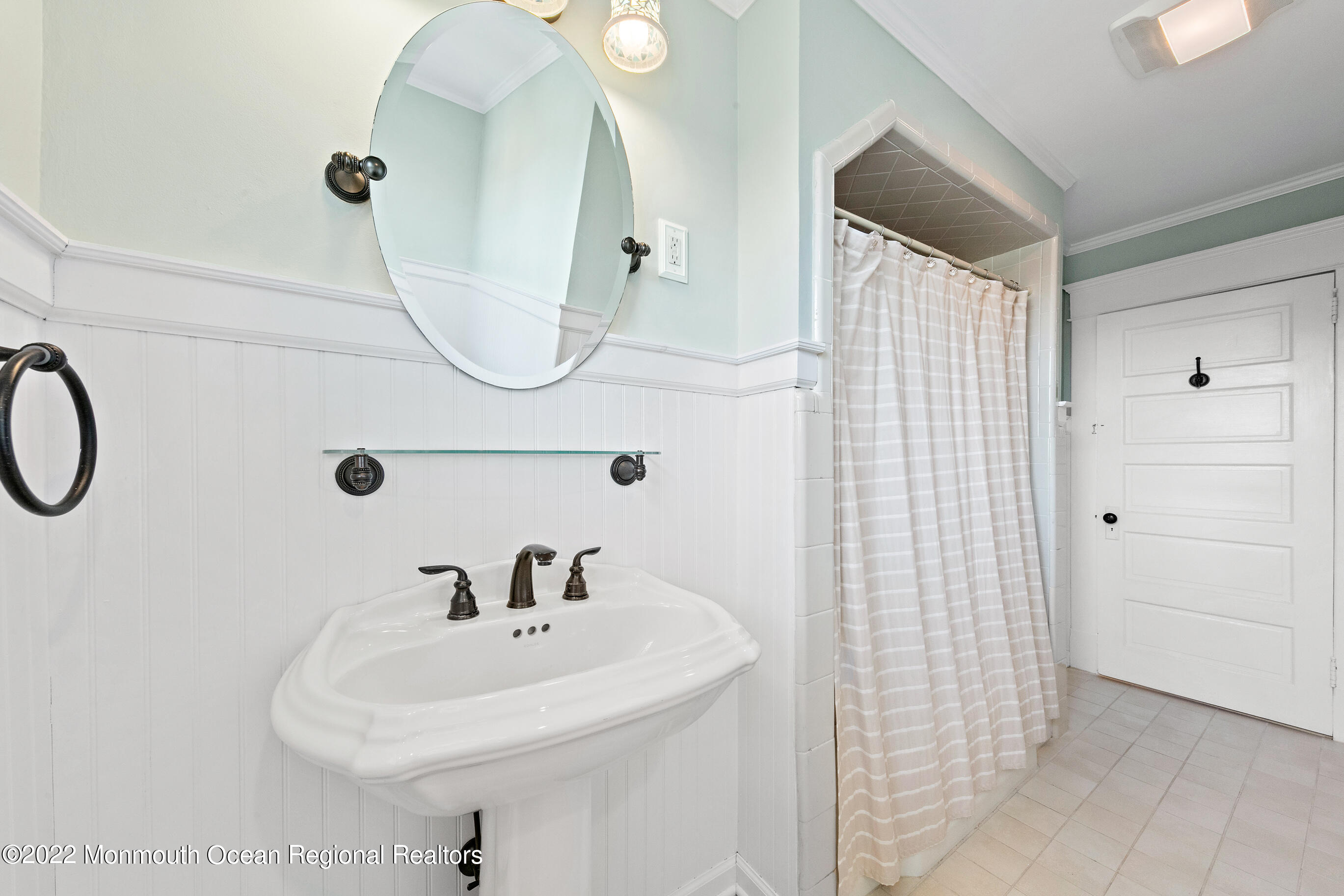 116 Tuttle Avenue, Unit WINTER 20232024 Spring Lake, NJ 07762 - Photo 37 of 44 a bathroom with a sink a mirror and shower