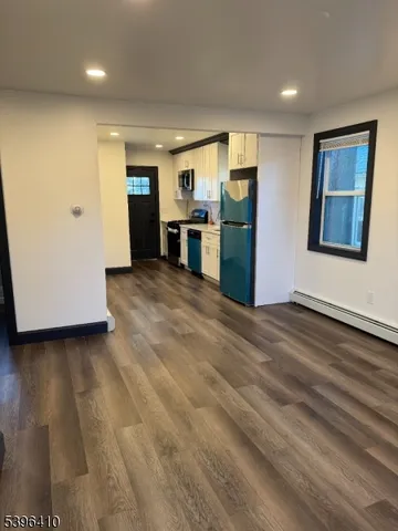 a view of a kitchen with a refrigerator and a window