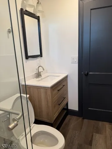 a bathroom with a sink a toilet and mirror