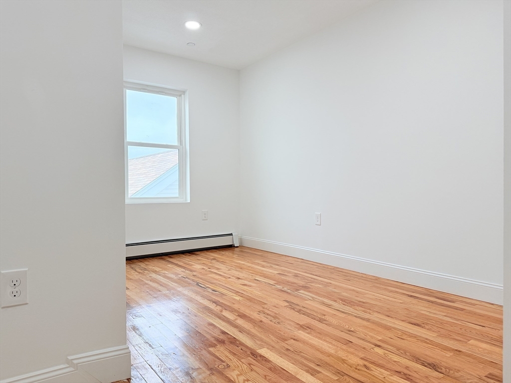 23 Bellevue Street, Unit 3 Worcester, MA 01609 - Photo 10 of 26 an empty room with wooden floor and windows