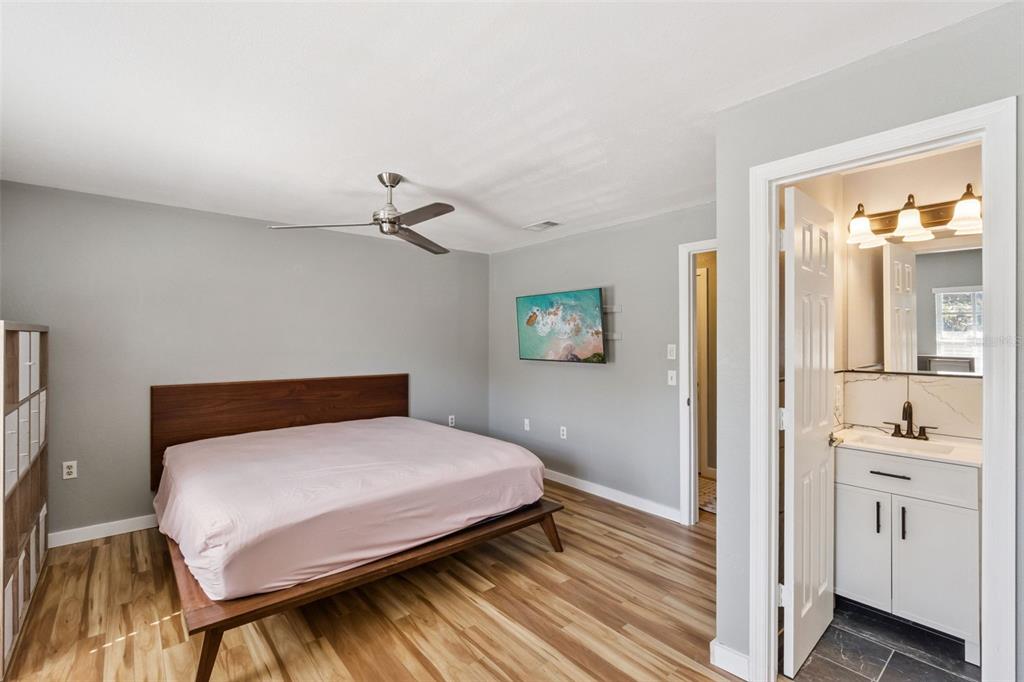 2613 East Church Street Orlando, FL 32803 - Photo 11 of 32 a bedroom with a bed and a view of kitchen