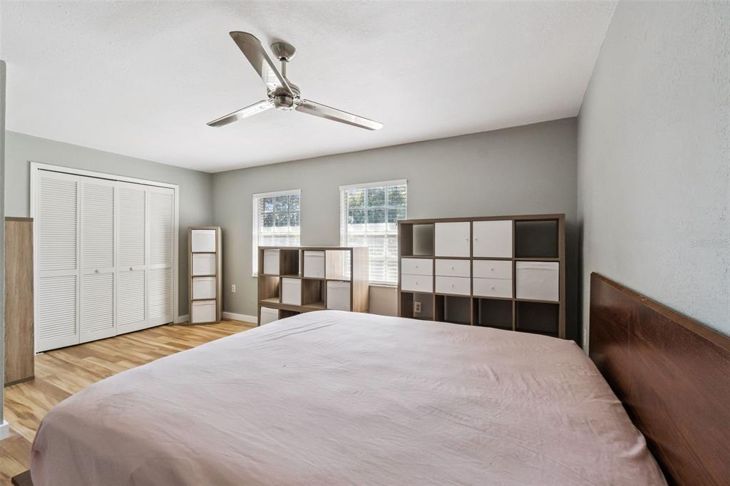 2613 East Church Street Orlando, FL 32803 - Photo 12 of 32 a bedroom with a large bed and a chandelier