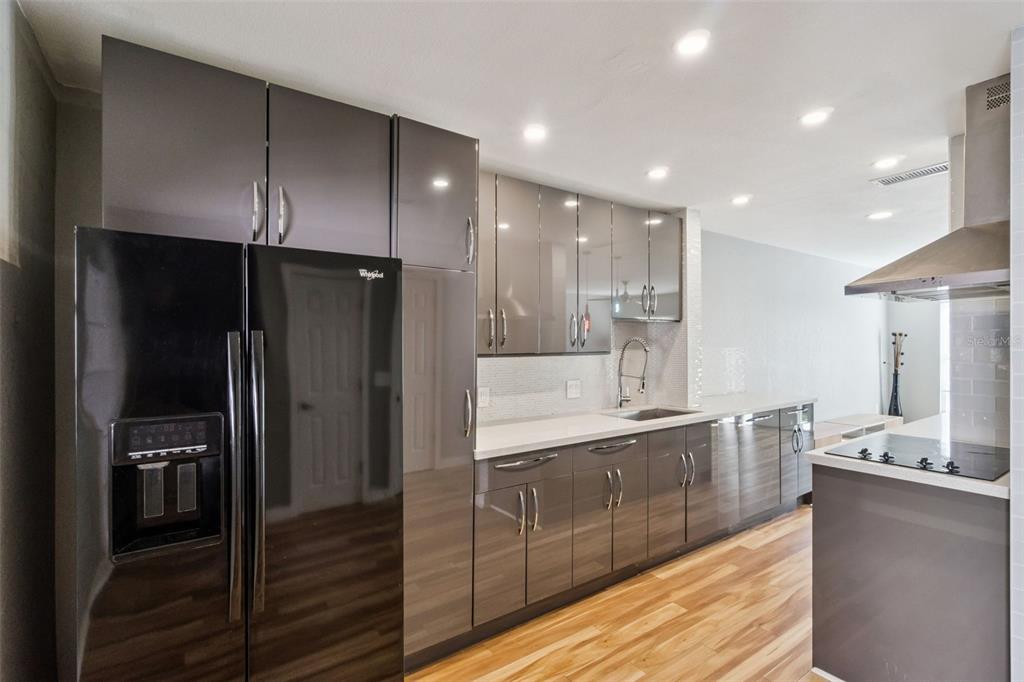 2613 East Church Street Orlando, FL 32803 - Photo 8 of 32 a large kitchen with a large counter top stainless steel appliances and cabinets