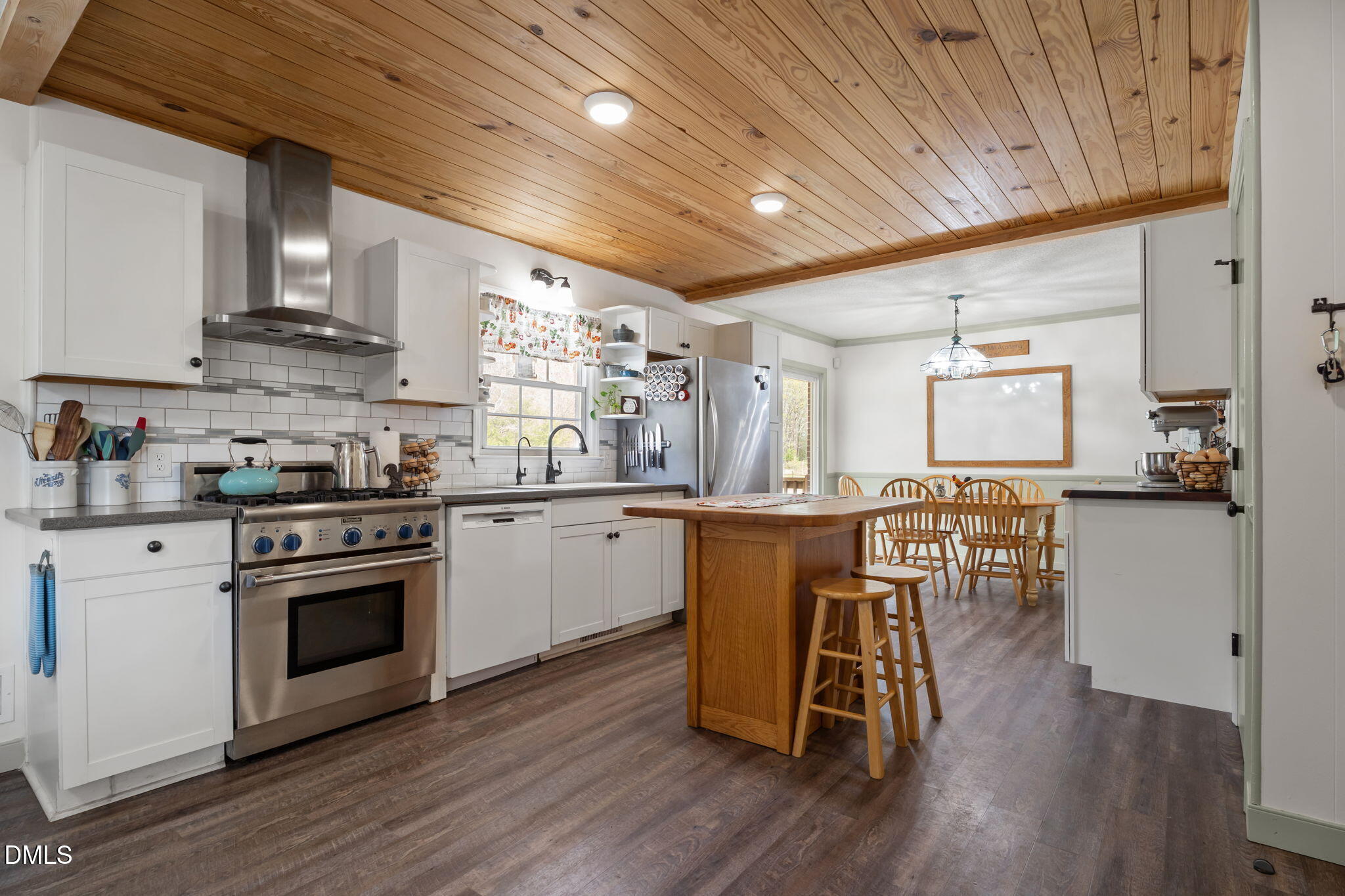 4313 Mitchell Mill Road Wake Forest, NC 27587 - Photo 9 of 45 a kitchen with stainless steel appliances granite countertop wooden floors a stove and white cabinets