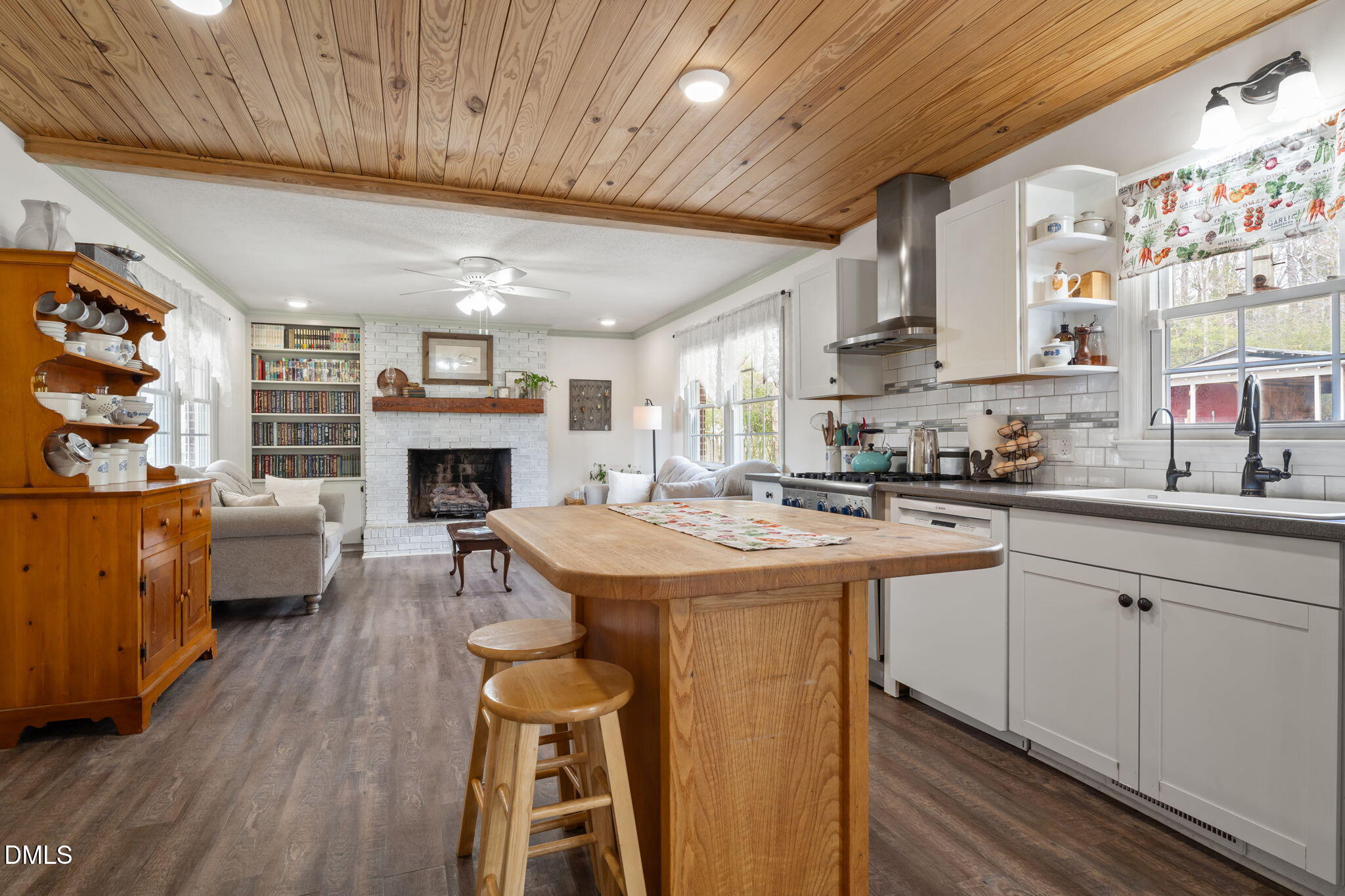 4313 Mitchell Mill Road Wake Forest, NC 27587 - Photo 11 of 45 a kitchen with furniture a large window and a fireplace
