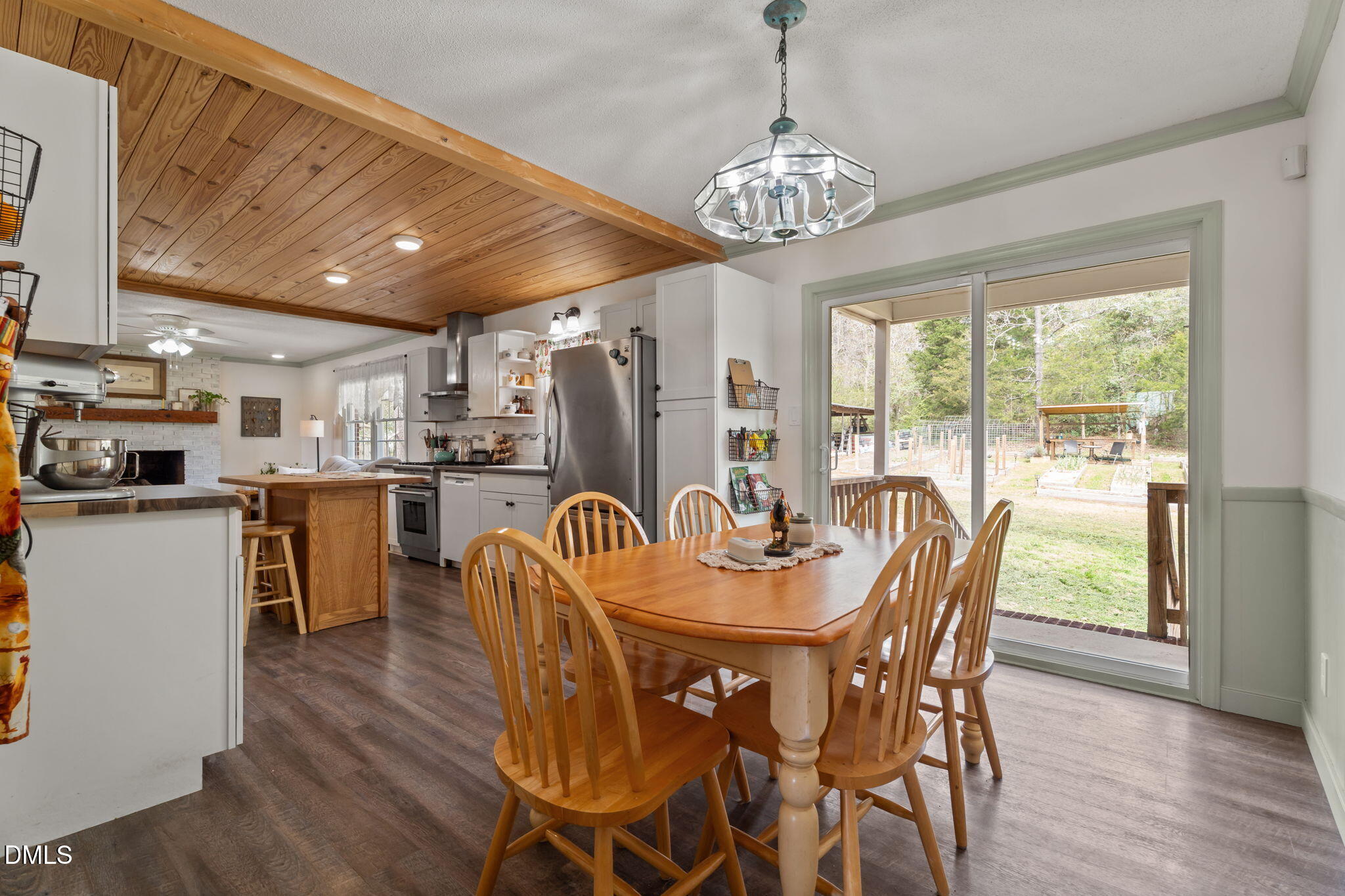 4313 Mitchell Mill Road Wake Forest, NC 27587 - Photo 13 of 45 a dining room with furniture a chandelier and wooden floor