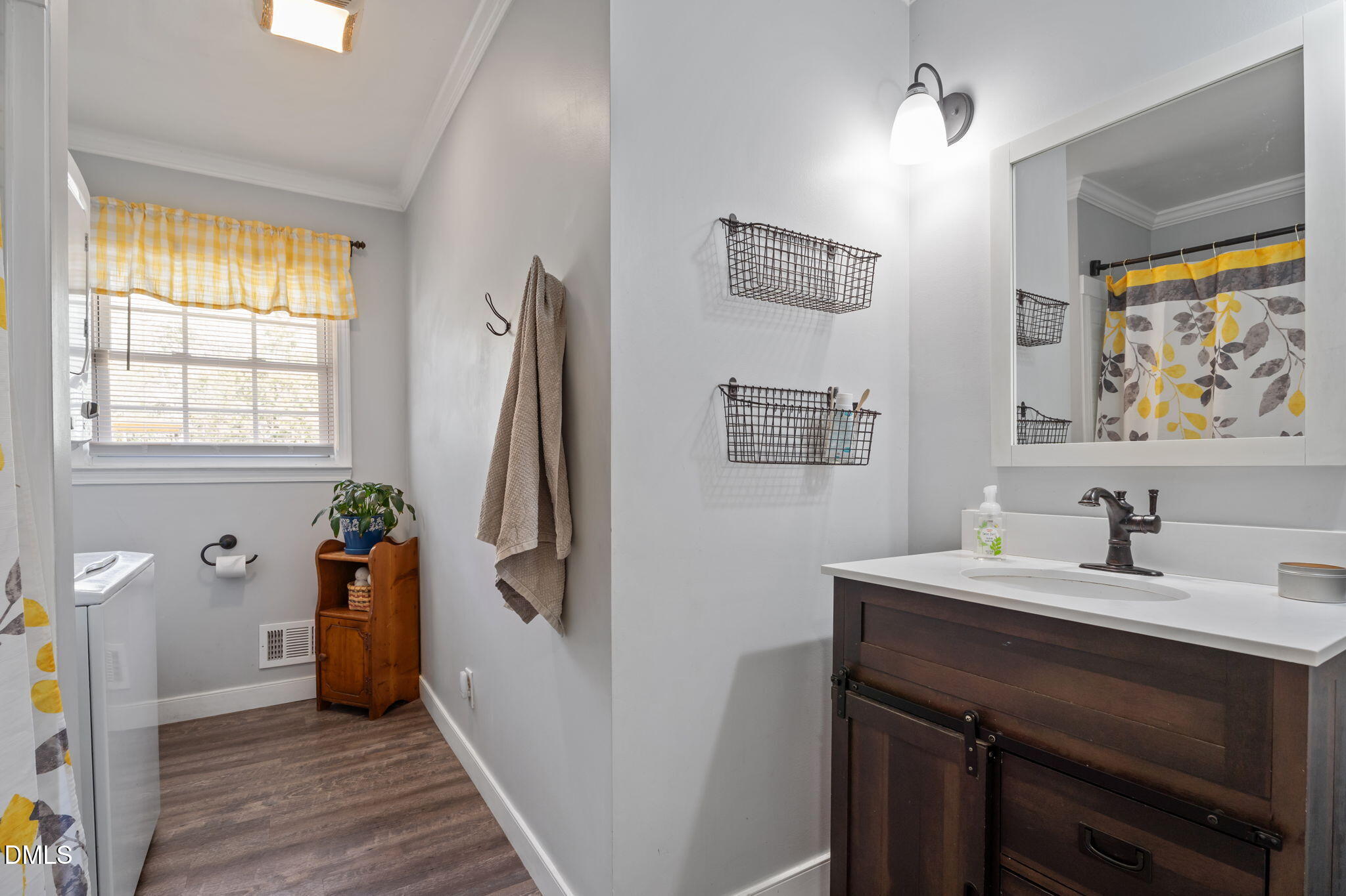 4313 Mitchell Mill Road Wake Forest, NC 27587 - Photo 19 of 45 a bathroom with a sink a toilet and a mirror