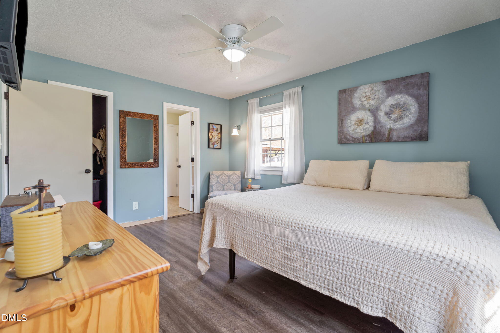 4313 Mitchell Mill Road Wake Forest, NC 27587 - Photo 23 of 45 a bedroom with a large bed and a chandelier