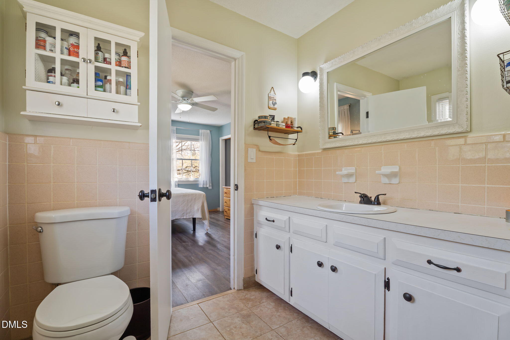4313 Mitchell Mill Road Wake Forest, NC 27587 - Photo 24 of 45 a bathroom with a toilet a sink and mirror